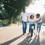 living trusts, image of parents helping child learn to ride a bike