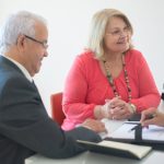 estate planning awareness month, image of older couple meeting with a professional