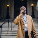incapacity planning, image of businessman talking on a phone outdoors