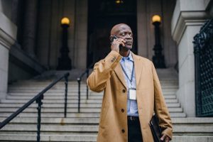 incapacity planning, image of businessman talking on a phone outdoors