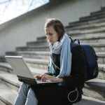 advance health care directives, image of young woman sitting on stairs outside using a laptop